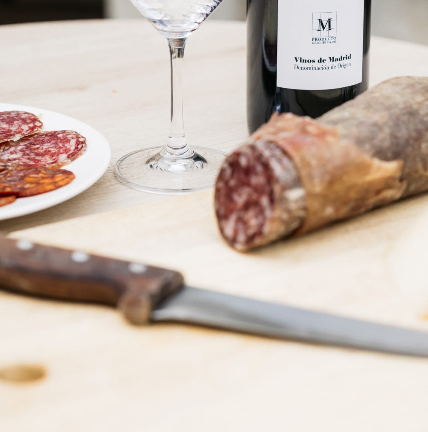 Cured sausage and wine bottle on a wooden table